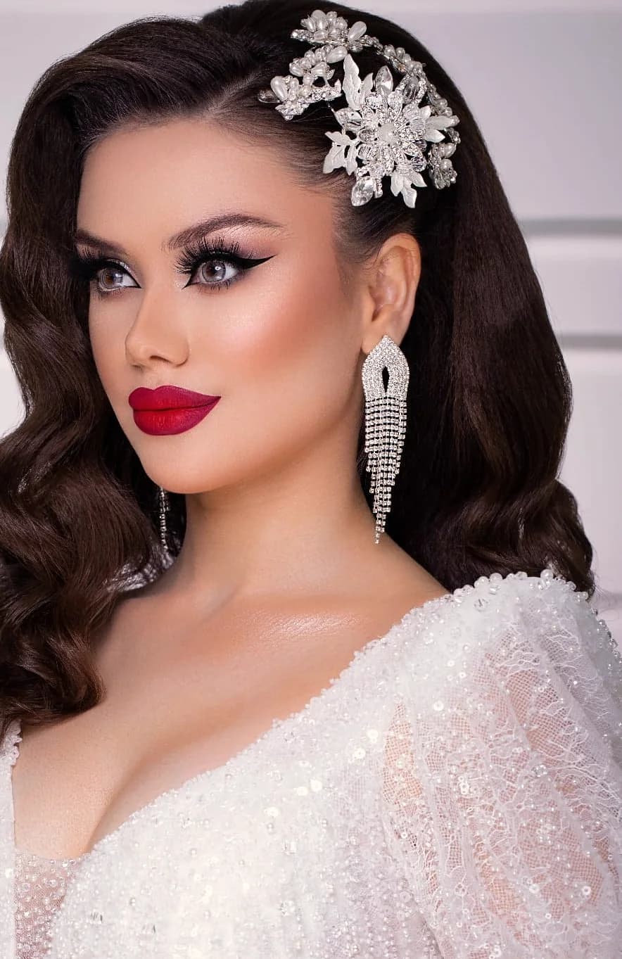 Dark waves with a crystal floral hairpiece, and a crimson lip