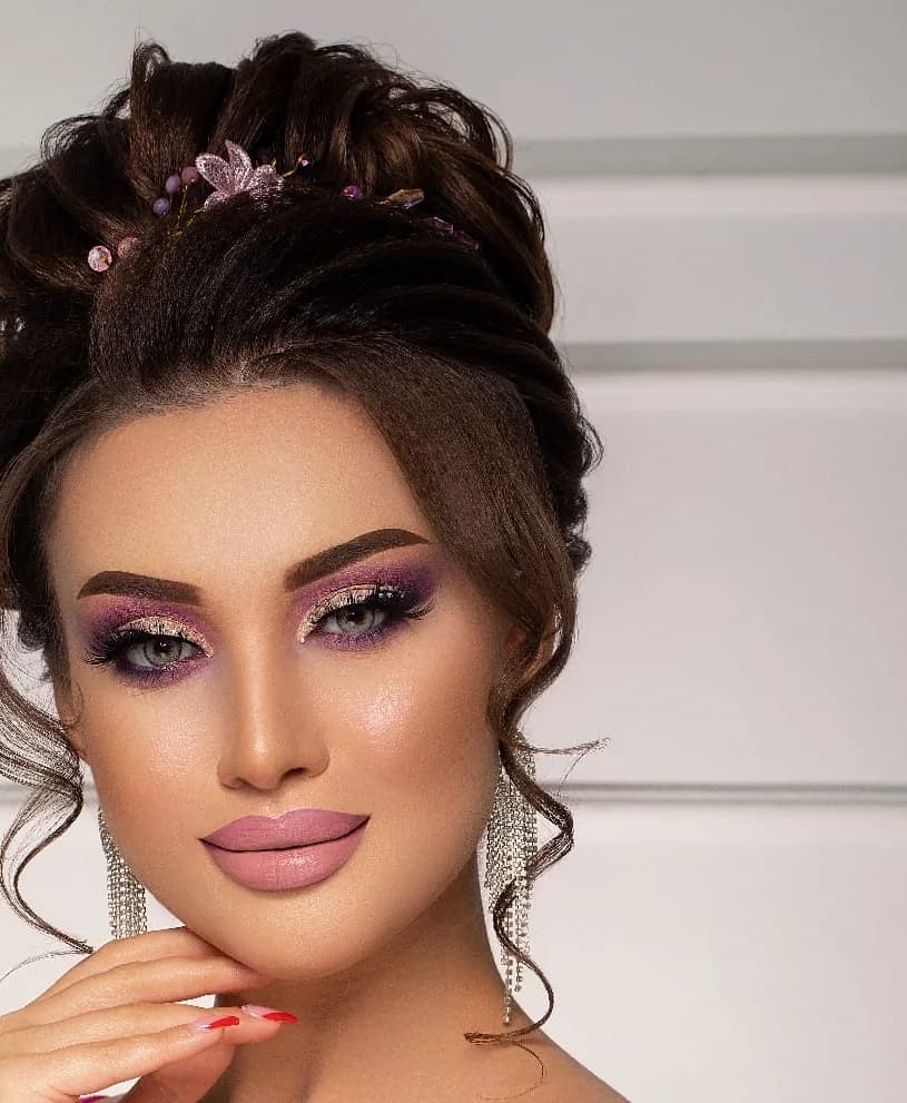A high textured updo with a jewelled pin, and a smoked eye